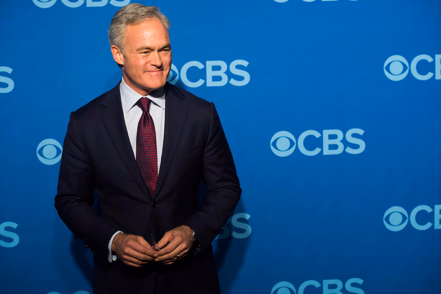 Tim Haugh - the former head of the NSA - standing in front of CBS branded backdrop