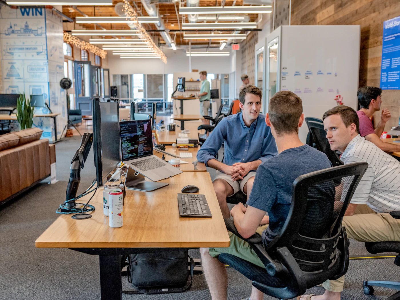 Colleagues discussing their work in a shared office