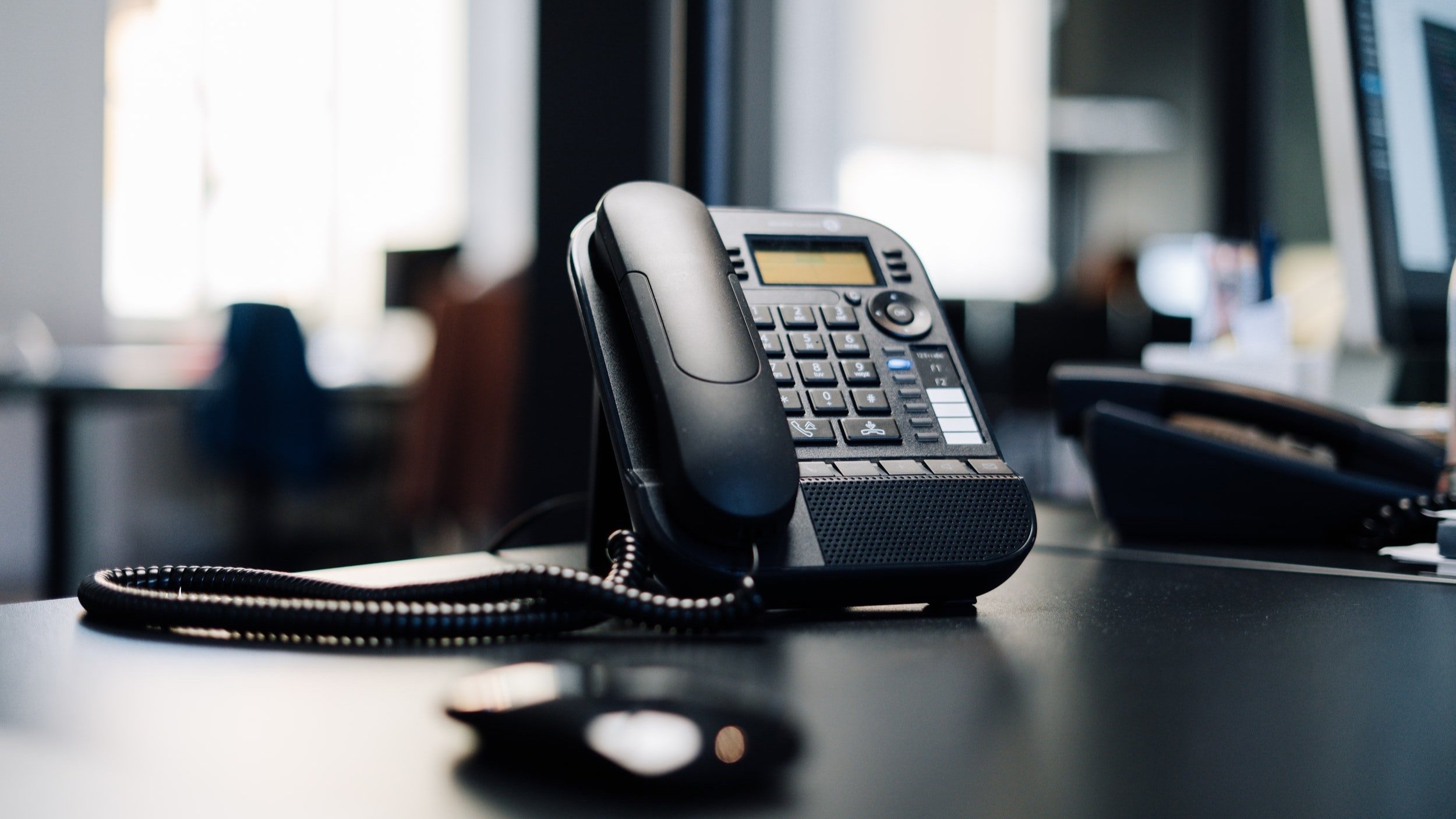 A business telephone on an office desk