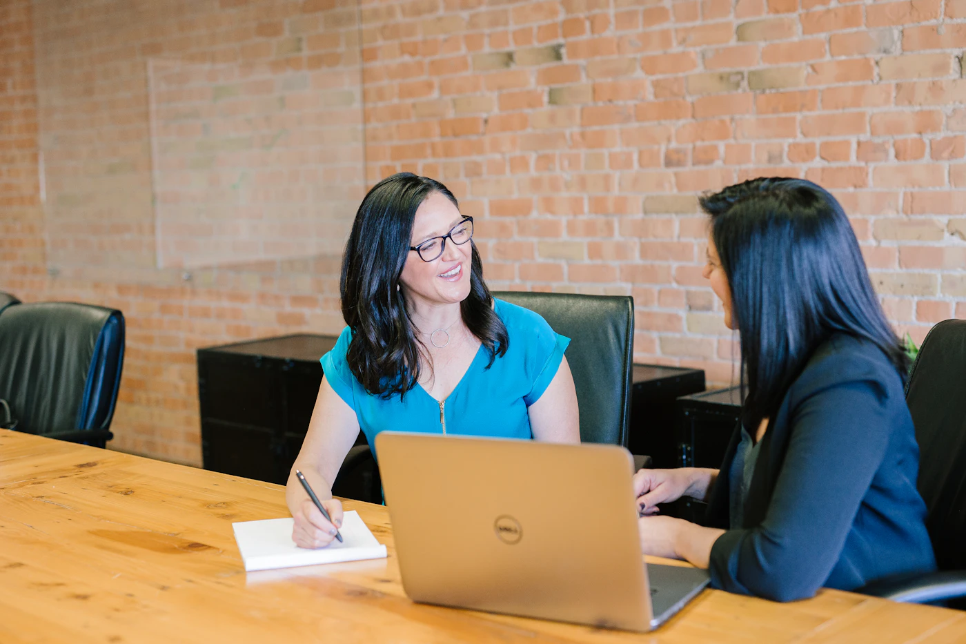 Two professionals planning together at a meeting table
